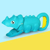 A teal plastic dinosaur toy with a yellow handle, designed as a beach or digging tool set.