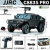 A black remote control off-road climbing vehicle with a machine gun accessory and related components.