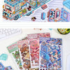 A sticker pack featuring whimsical cartoon penguins and dogs in an RV scene, displayed on white paper.