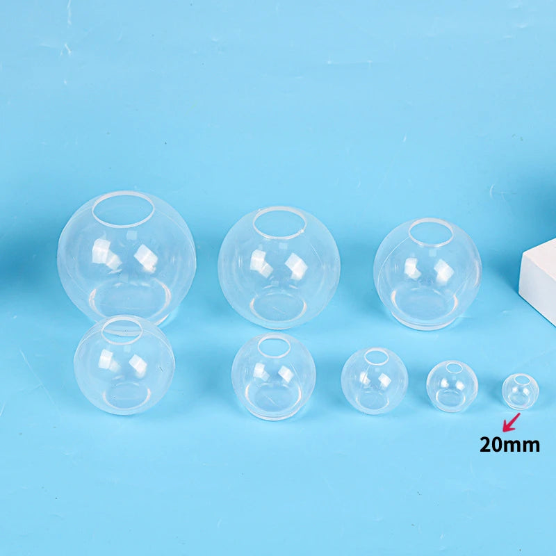 A collection of clear silicone sphere molds for resin crafting, showing various sizes and shapes.