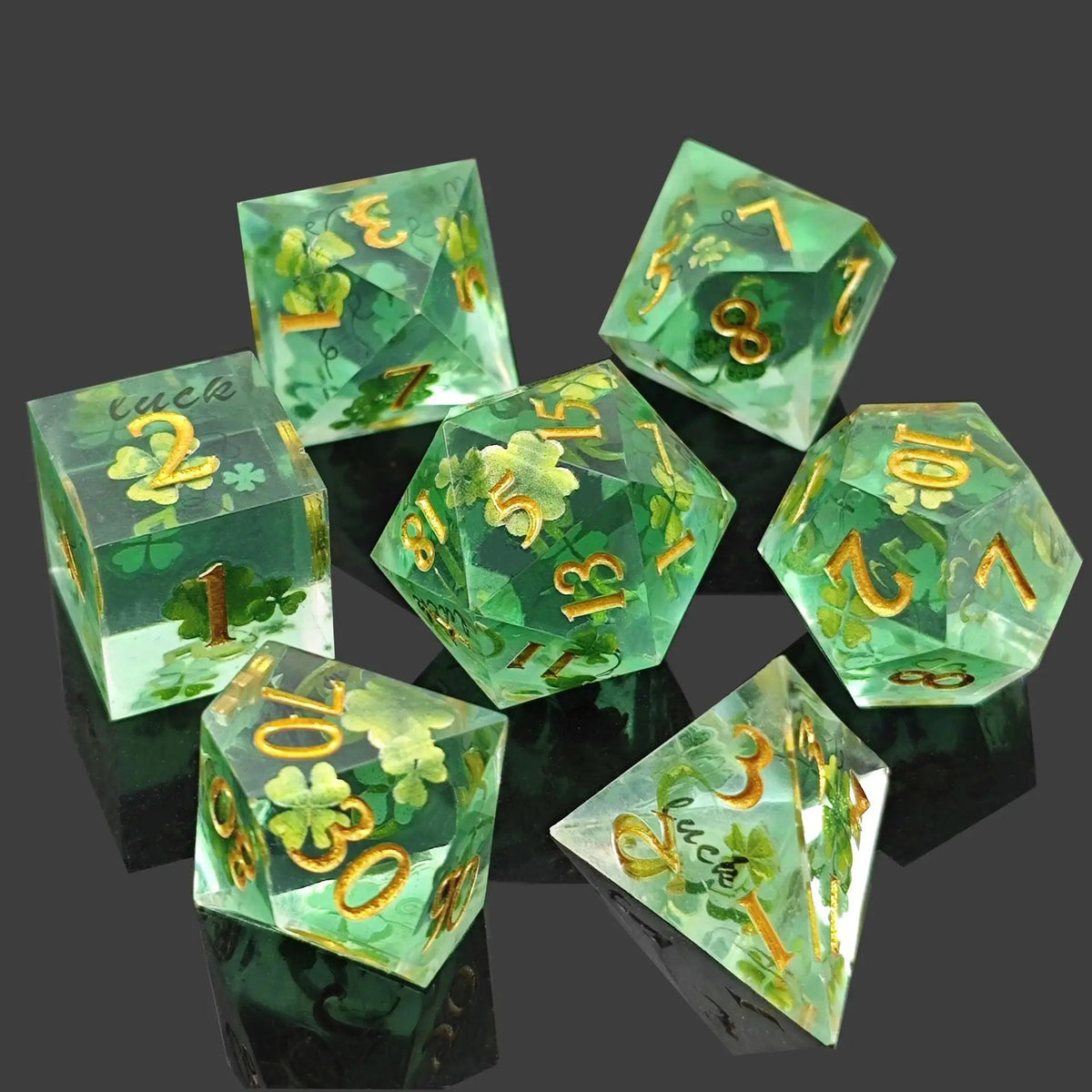A set of milk white resin dice featuring a black kitten design, arranged on a dark surface.