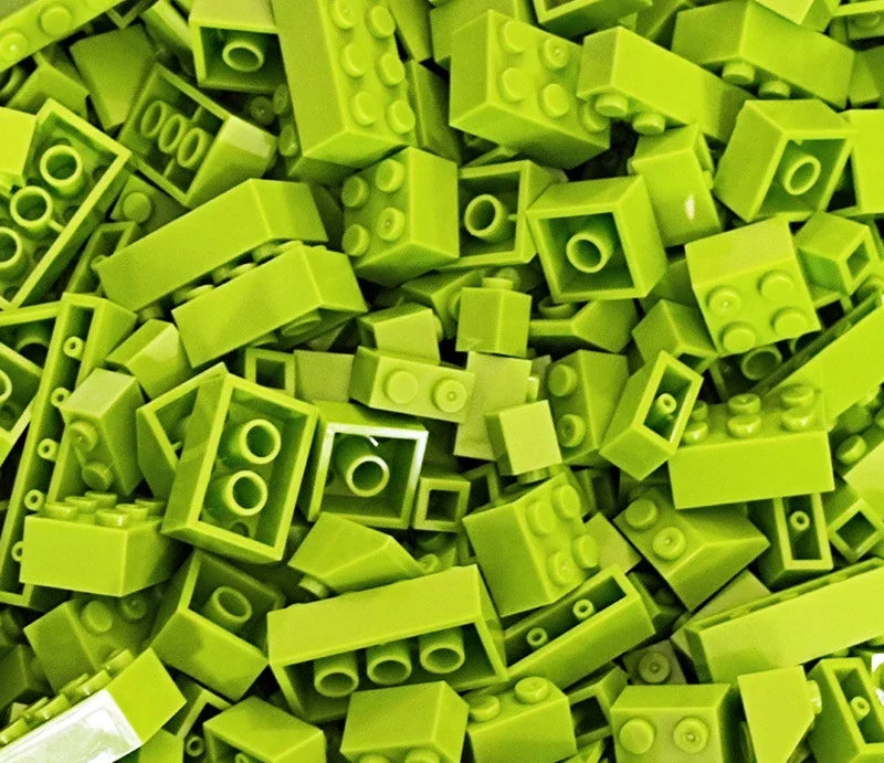 A pile of bright lime green plastic building blocks.
