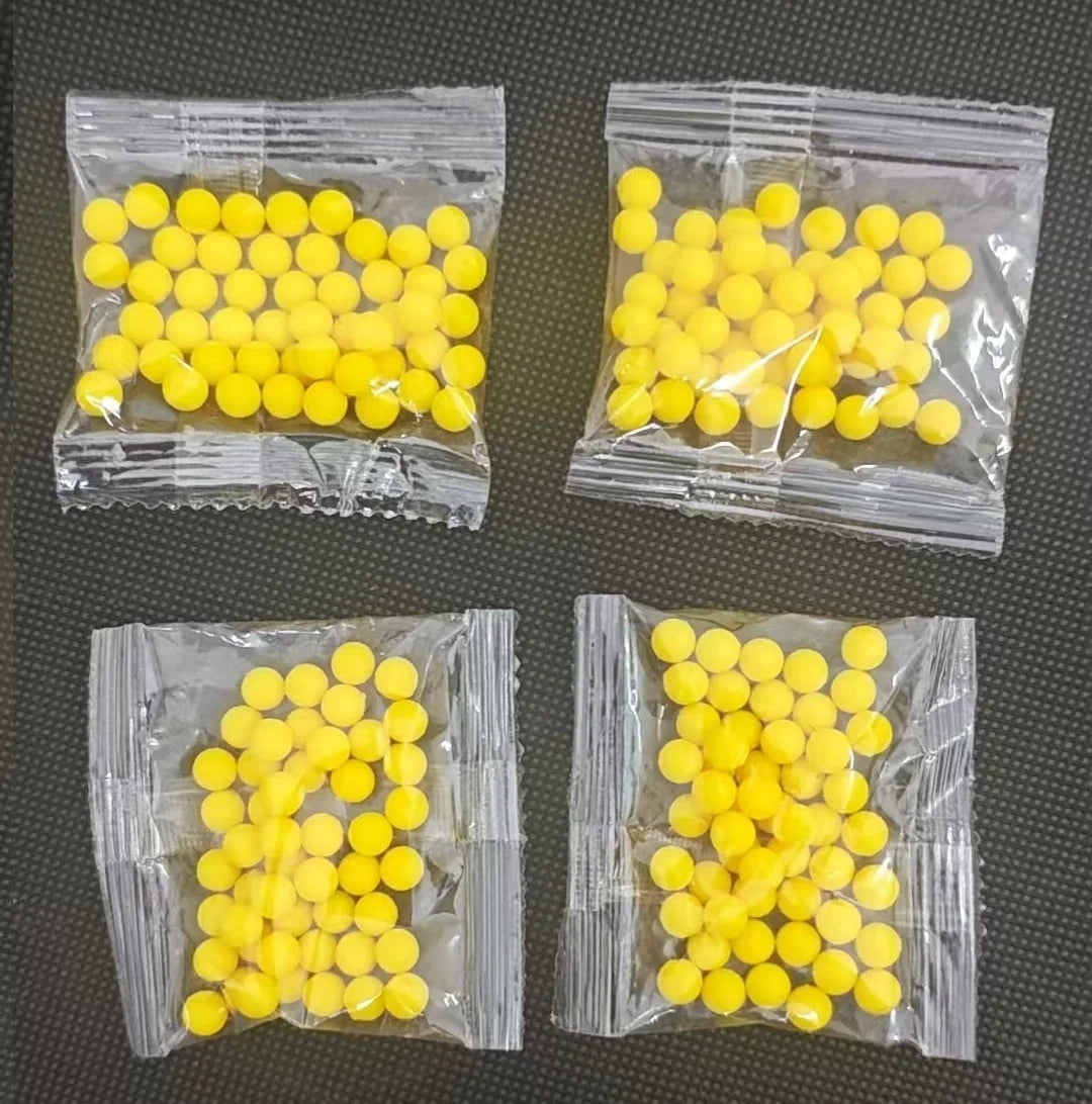 Several small plastic bags filled with yellow silicone finger ring launcher fidget toys