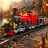 A detailed model of a red and black vintage steam passenger train locomotive on a railway track set against a scenic, autumna