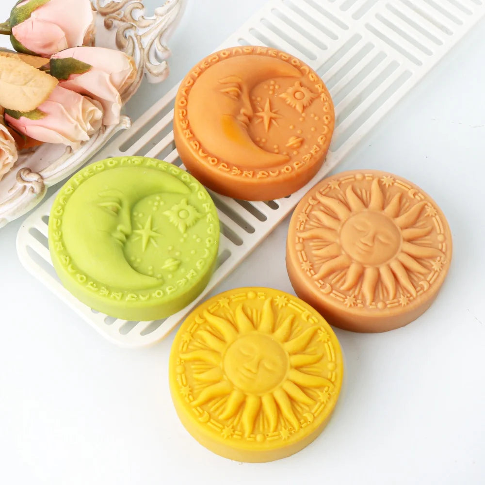 Three silicone molds shaped like the sun, moon, and face are displayed on a white tray.