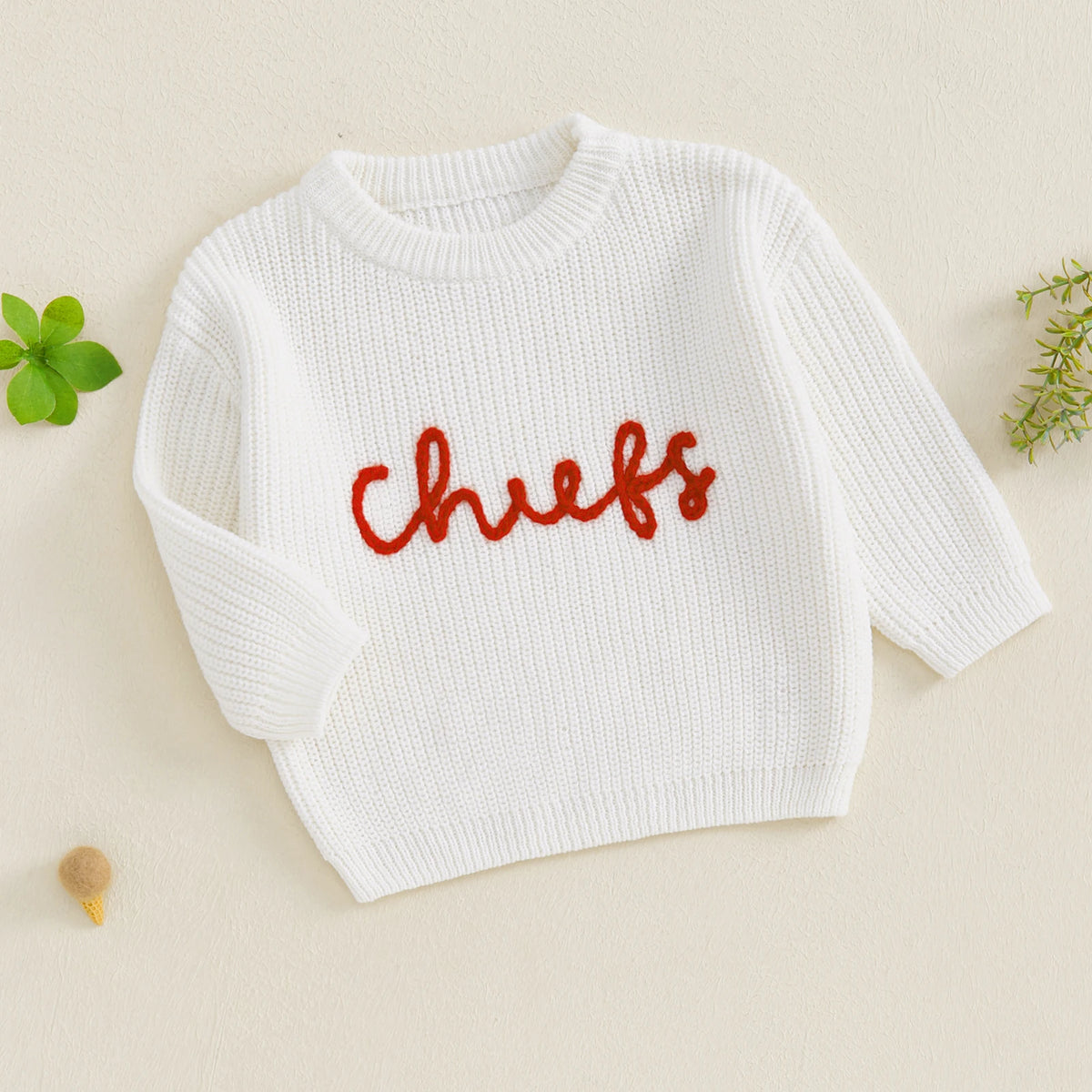 White knit sweater for baby or kids with red embroidery spelling out chefs