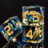 A set of five blue resin dice with gold markings are displayed on a dark surface.
