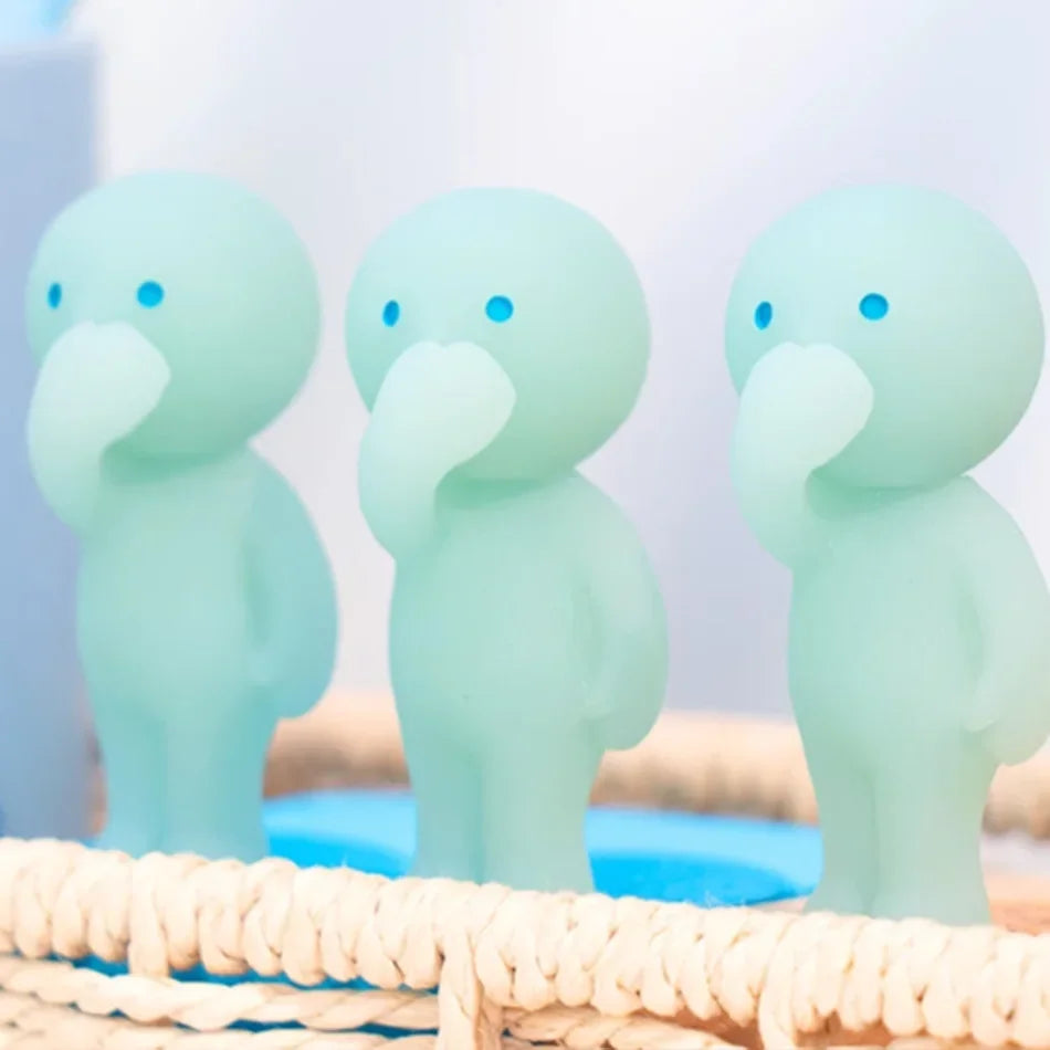 Three glowing light blue mini fitness figurines sitting on a woven surface.