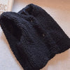 A dark gray, textured wool vest with buttons is shown on a light background.