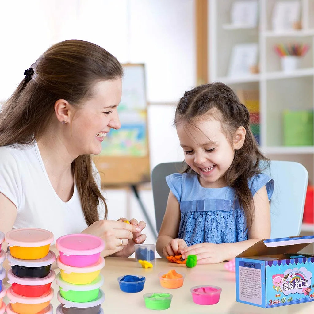 A young girl is playing with a set of 24-color ultra light modeling clay, featuring various colored molds and tools.