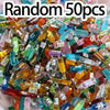 A pile of random 50 pieces of miniature dollhouse food items including cake, wine, and various snacks.