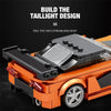 A building block set of a classic orange sports car model showing the taillight design detail.