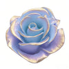 A light blue silicone flower mold with gold accents, shaped like a rose, used for decorating cakes and fondant.