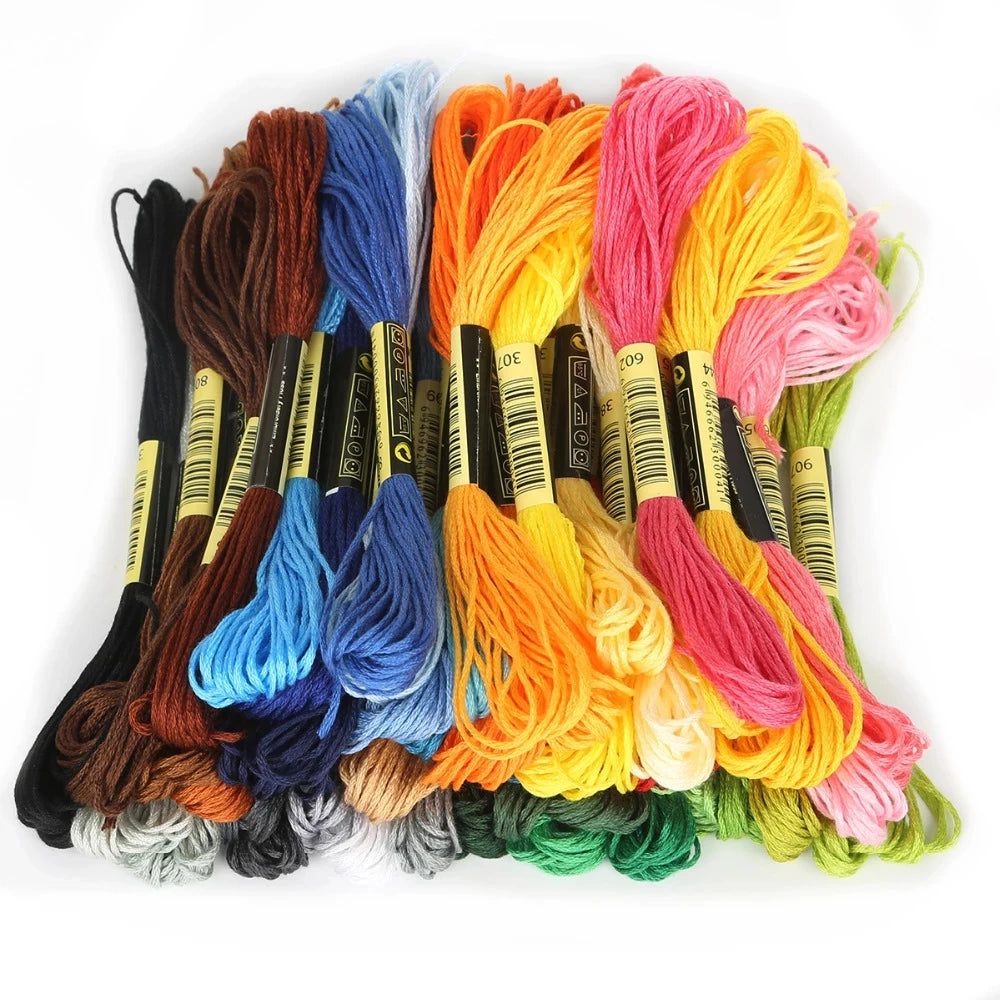 A collection of multicolor embroidery floss skeins in various shades including orange, pink, blue, and green.