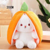 A white bunny plush toy is nestled inside an orange fruit-shaped fabric, resembling a pumpkin or citrus fruit.