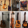 A collection of guitars displayed on a wall mount hanger with soft padding.