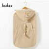 A beige baby windproof cape blanket featuring a dinosaur design, displayed on a hanger.