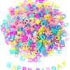 A pile of colorful acrylic alphabet letter beads in various bright colors for jewelry making and crafts