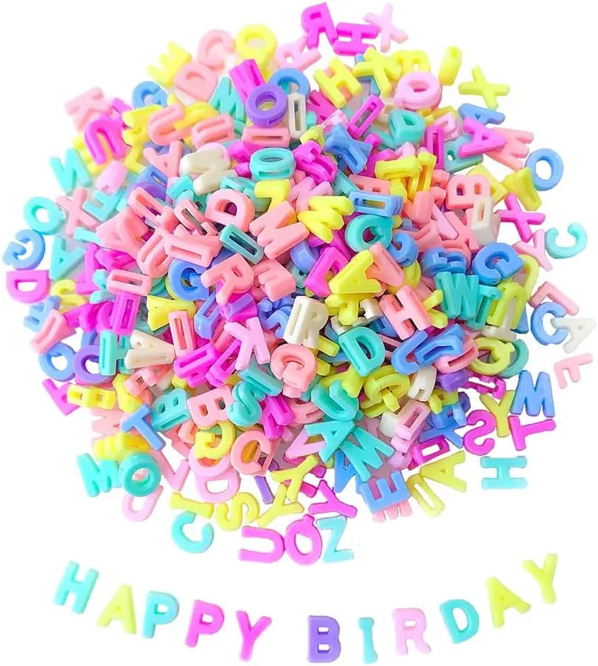 A pile of colorful acrylic alphabet letter beads in various bright colors for jewelry making and crafts