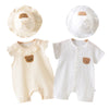 A white cotton muslin baby romper and hat set for summer, featuring a textured fabric.