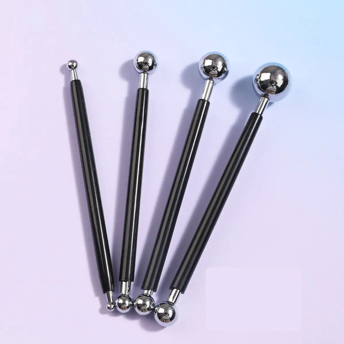 A set of four metal clay sculpting tools with black handles and silver balls for pottery and crafting.