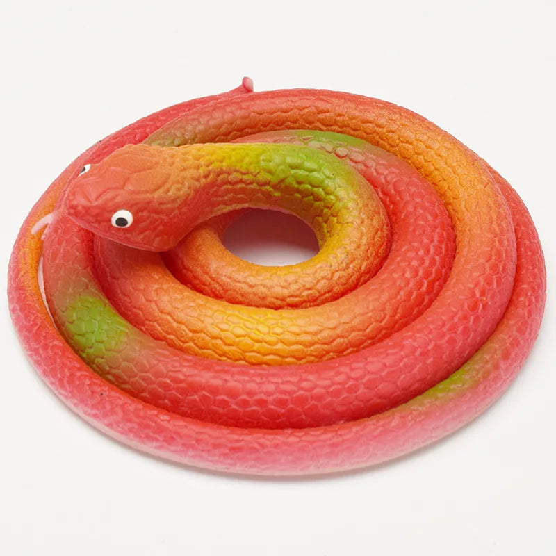 A realistic rubber snake toy coiled in shades of orange, red, and green.