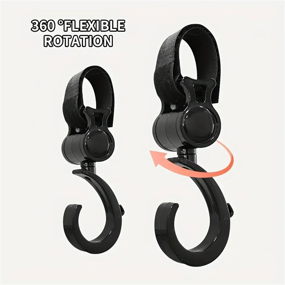 A pair of black 360° flexible rotating stroller hooks for diaper bags and shopping.