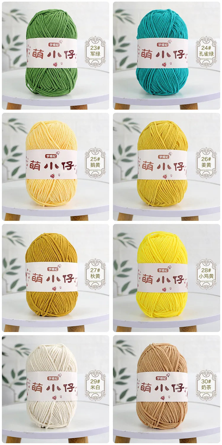 A collection of soft chenille yarn balls in various shades of green, yellow, and beige, labeled with thread counts.