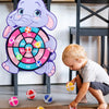 A purple elephant character holding a colorful dart board with sticky balls on a wooden floor.