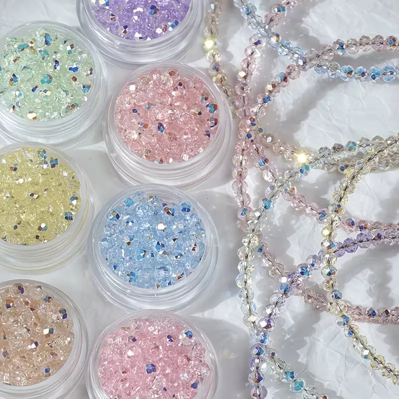 A collection of colorful glitter beads in various shades including pink, blue, and gold are displayed for jewelry making.
