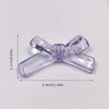 A clear purple acrylic bow tie bead shown with its dimensions.