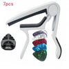 A white guitar capo holder with seven pieces including a capo, picks, and a holder.