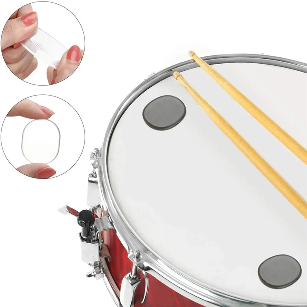 Close-up view of silicone drum dampening pads and a drum, showing the pads being placed on the drum head.