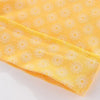 Yellow long-sleeve baby shirt with a white sun pattern