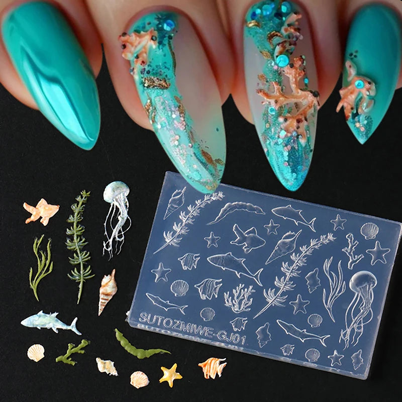 A set of silicone nail art molds featuring ocean themes like fish, starfish, and sea creatures on a clear plastic sheet.