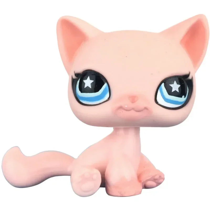 A pink cat bobble head figurine with large blue eyes and a small tail.