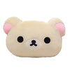 A soft plush pillow shaped like Rilakkuma with light beige fur and pink ears.
