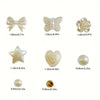 A collection of white acrylic pearl beads and findings including bows, butterflies, stars, hearts, and round pearls for jewel