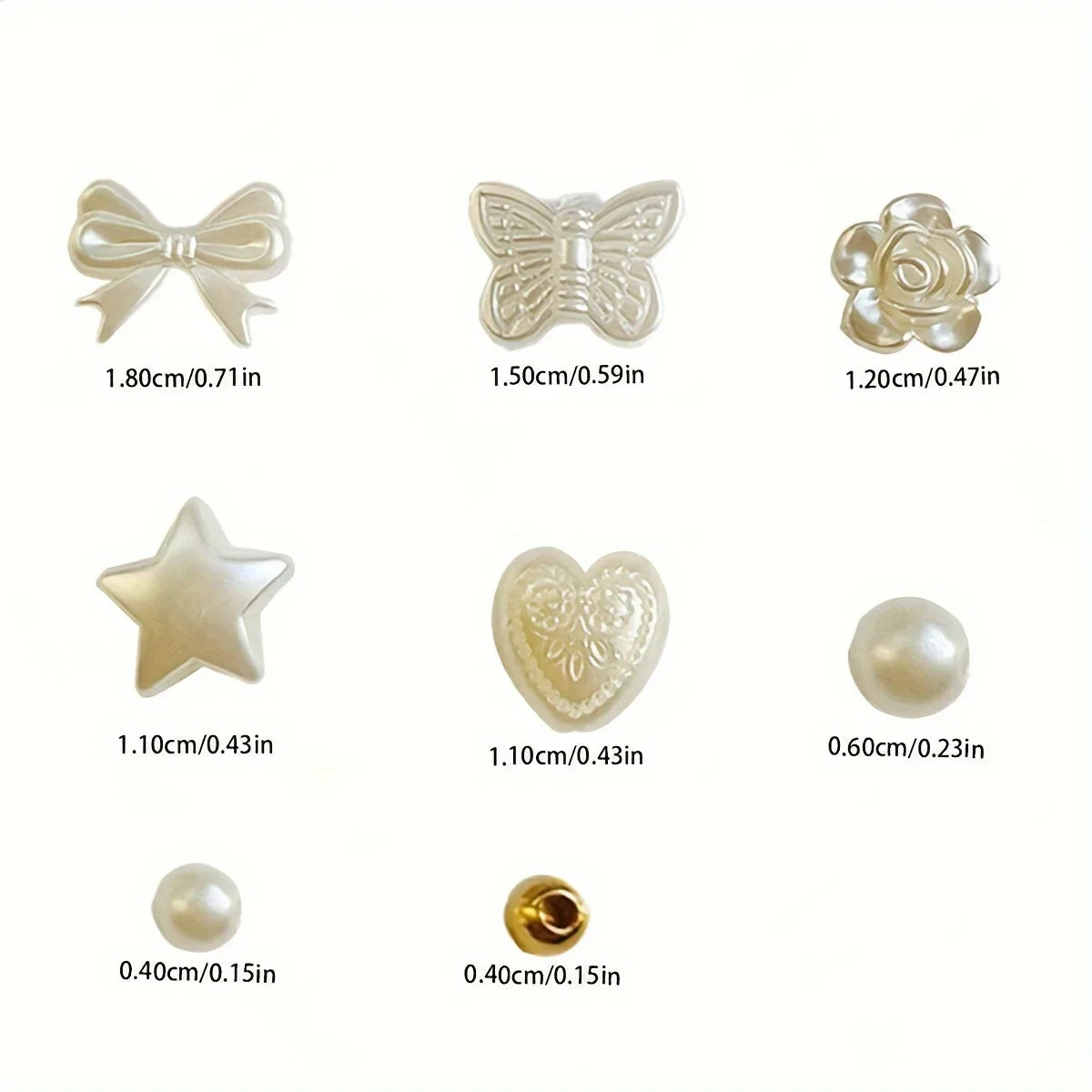 A collection of white acrylic pearl beads and findings including bows, butterflies, stars, hearts, and round pearls for jewel