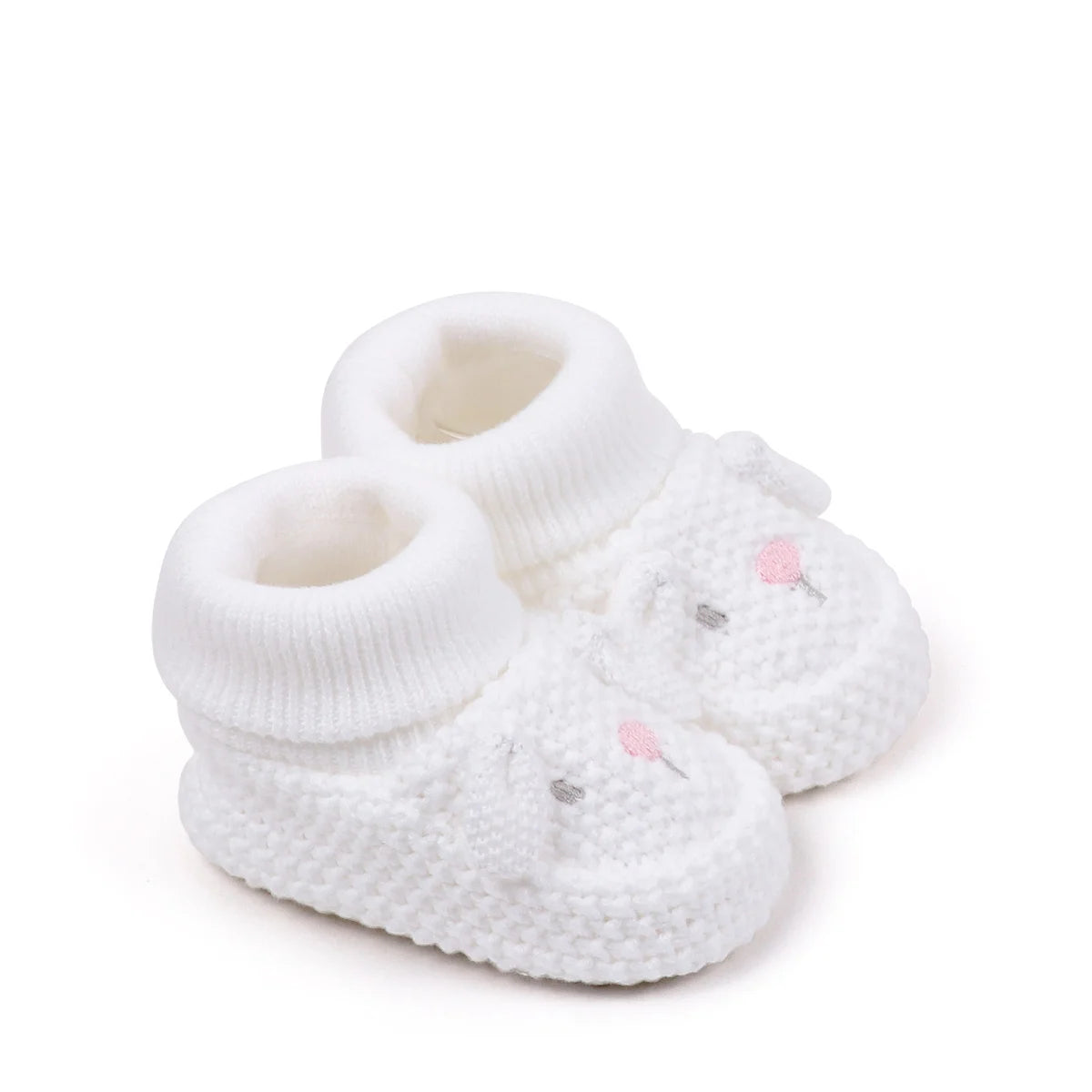 A pair of white knitted baby booties with pink accents and non-slip soles.