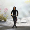 A black plush doll resembling Michael Jackson standing in a snowy outdoor setting.