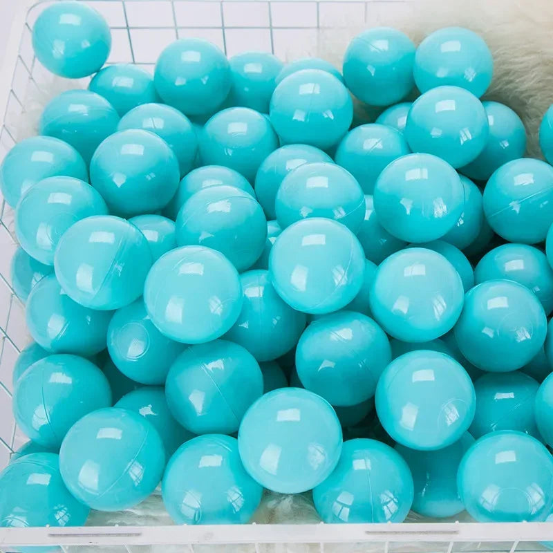 A collection of light blue and turquoise plastic play balls are displayed in a white tray.
