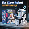 A white six claw robot toy is shown next to its packaging, with music notes floating around it.