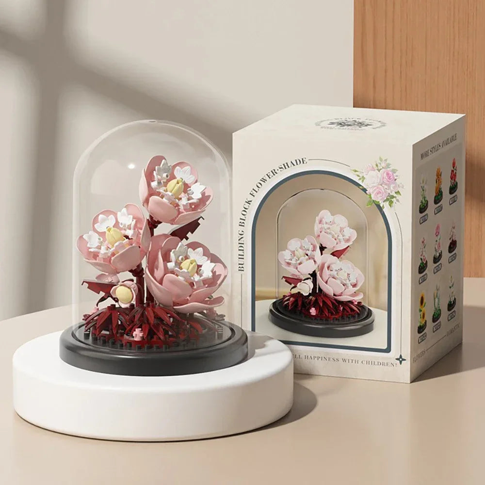 A set of building blocks for creating an eternal bouquet featuring pink and white flowers.