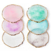 A set of five round resin nail art palettes with gold trim in shades of pink, green, and white.
