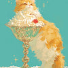 A fluffy orange cat sits beside a glass bowl filled with white foam and a red cherry on a lace cloth.