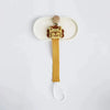 A wooden elephant pacifier holder with a clip mounted on a white tray.
