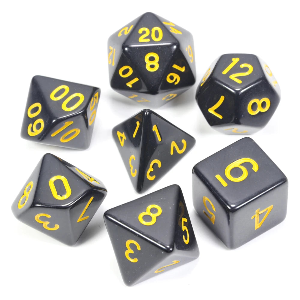 A collection of black acrylic dice showing various numbers and shapes used for tabletop role-playing games