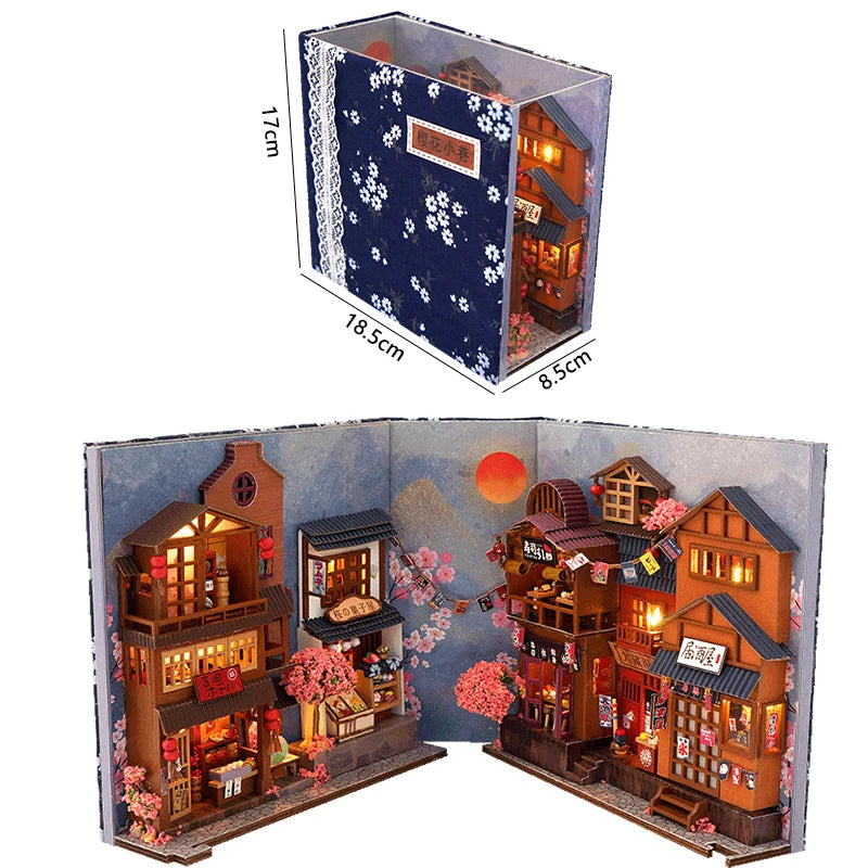 A DIY wooden book nook kit featuring a detailed Japanese alley miniature scene with illuminated buildings and seasonal foliag