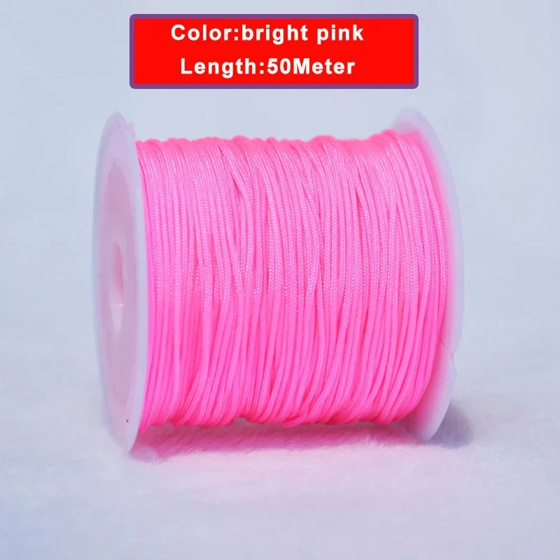 A spool of bright pink nylon knotting cord for jewelry making, 50 meters long.